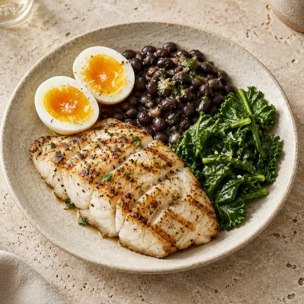 A plate of fish, eggs and beans
