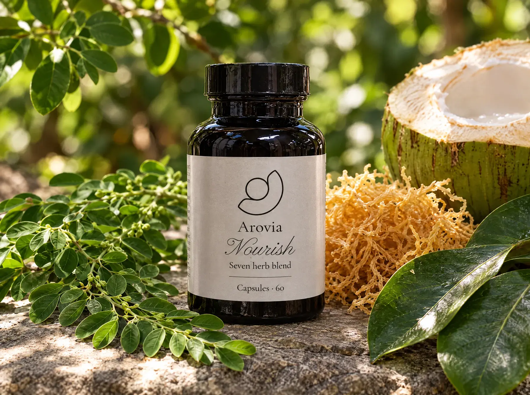 Arovia Nourish bottle on stone among moringa, sea moss and a fresh coconut