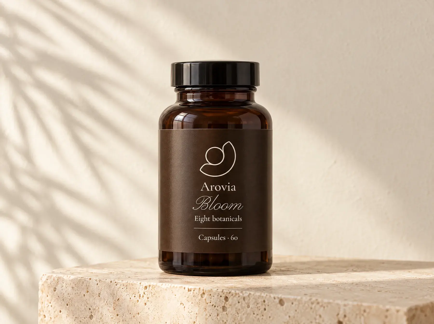 Arovia Bloom capsule bottle on a travertine plinth in soft morning light